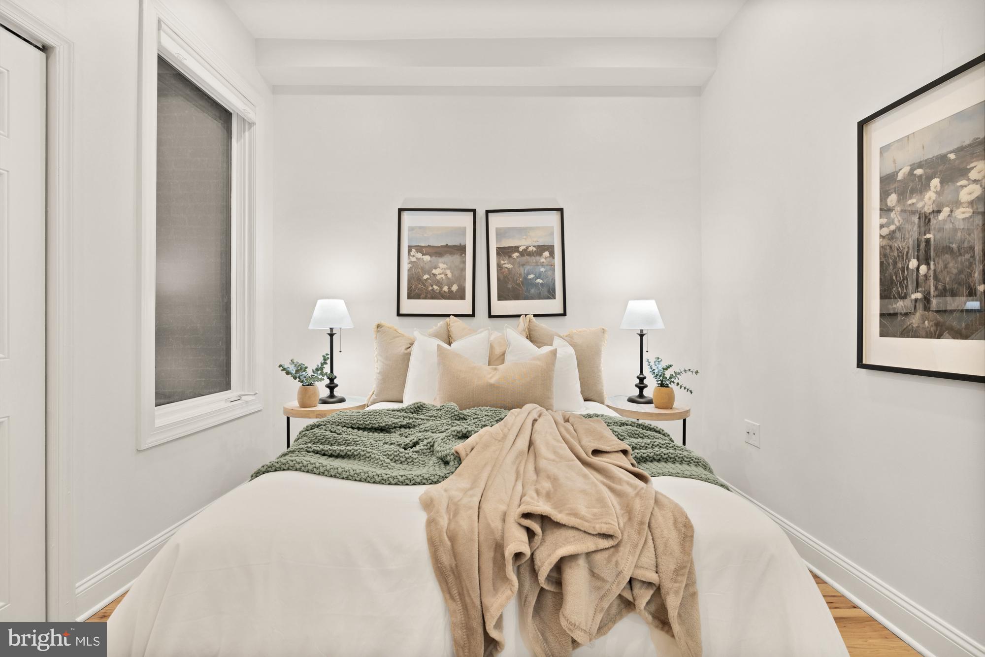 2713 Ontario Road Northwest, Unit 2 Washington, DC 20009 - Photo 18 of 33 a bedroom with a bed and a painting on the wall