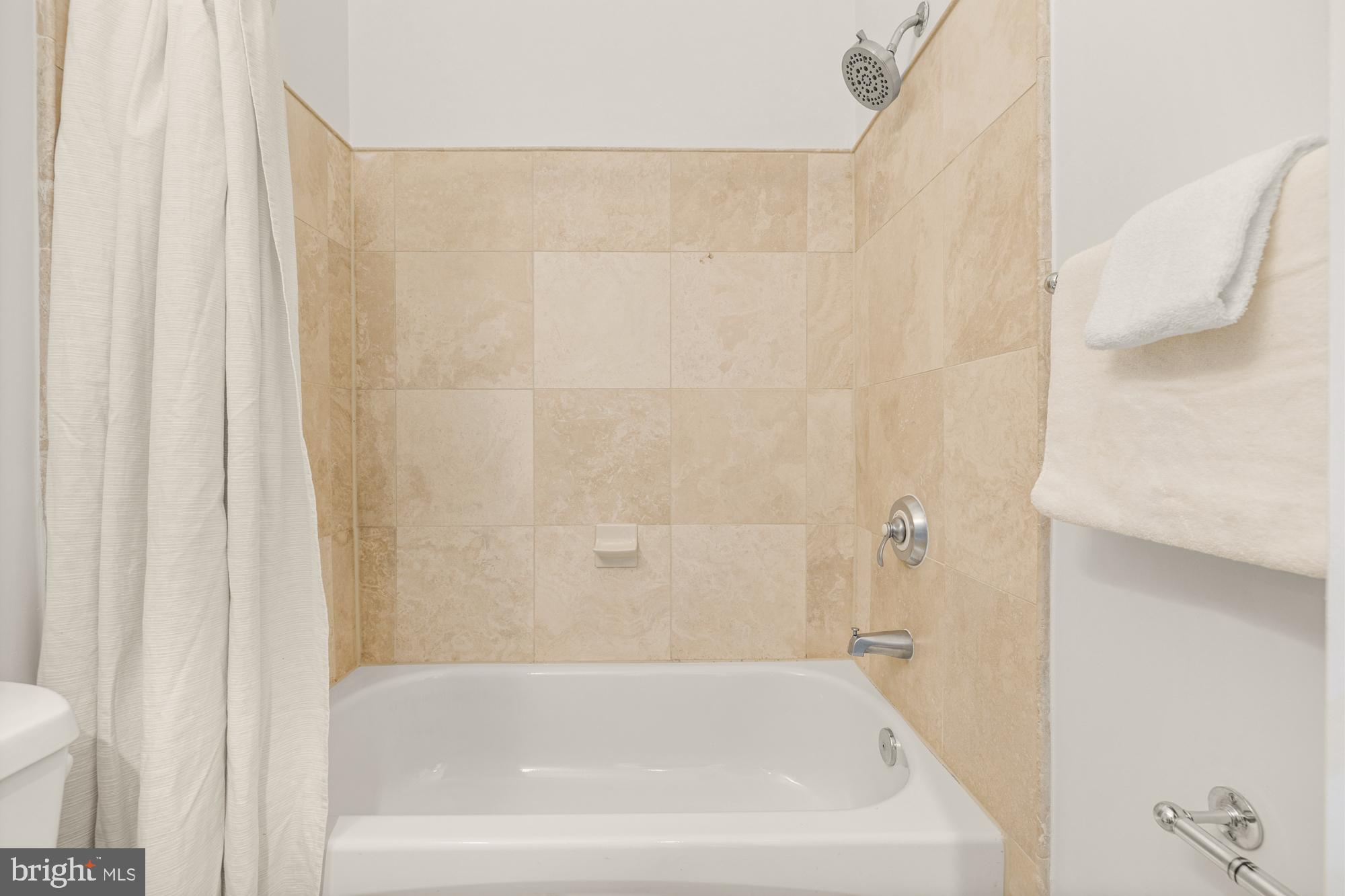 2713 Ontario Road Northwest, Unit 2 Washington, DC 20009 - Photo 21 of 33 a bathroom with a bathtub and shower