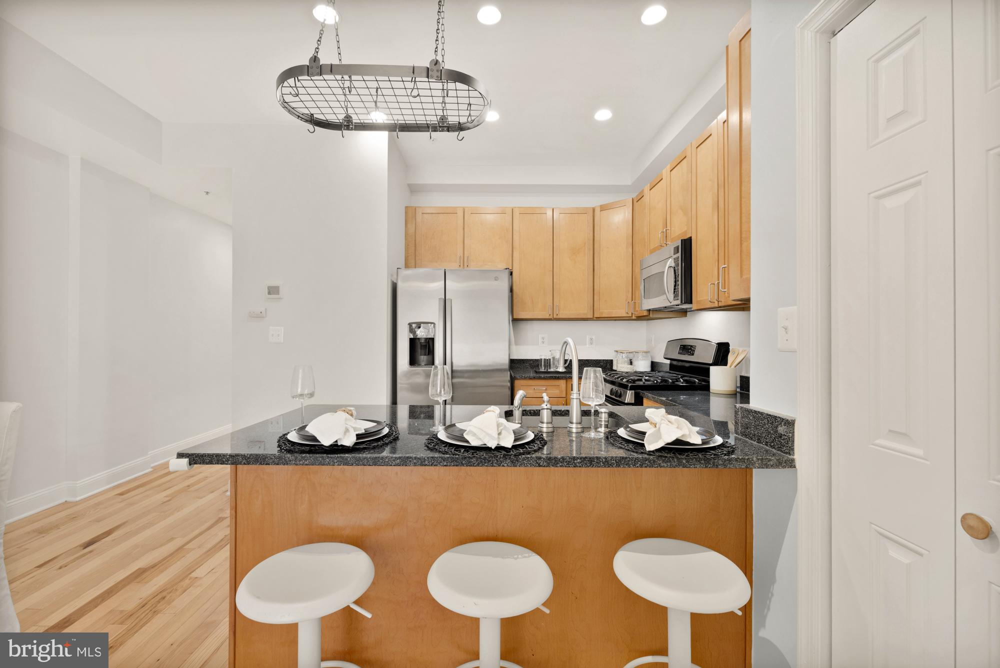 2713 Ontario Road Northwest, Unit 2 Washington, DC 20009 - Photo 10 of 33 a kitchen with a sink a stove and a refrigerator