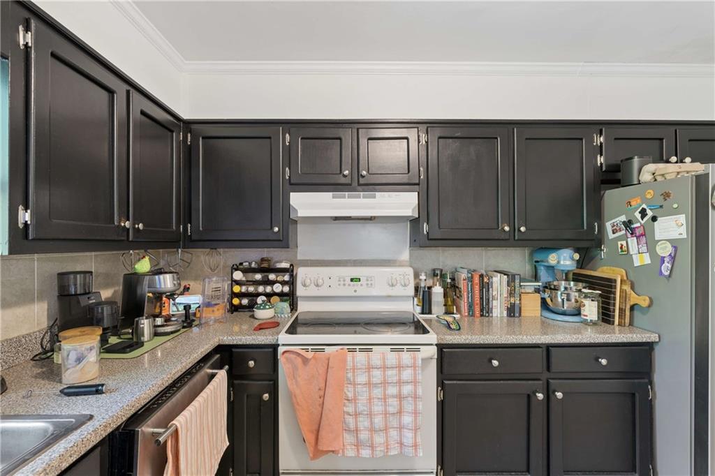 795 North Parkwood Road Decatur, GA 30030 - Photo 31 of 50 a kitchen with stainless steel appliances granite countertop a refrigerator and sink