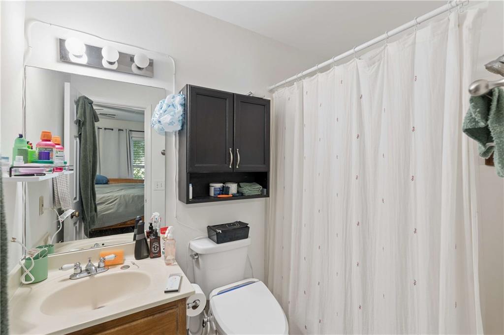 795 North Parkwood Road Decatur, GA 30030 - Photo 36 of 50 a bathroom with a sink a toilet and a mirror