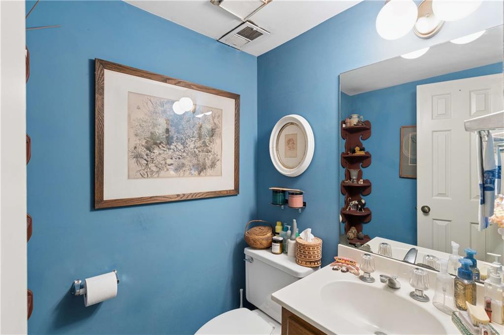 795 North Parkwood Road Decatur, GA 30030 - Photo 8 of 50 a bathroom with a toilet a sink and mirror