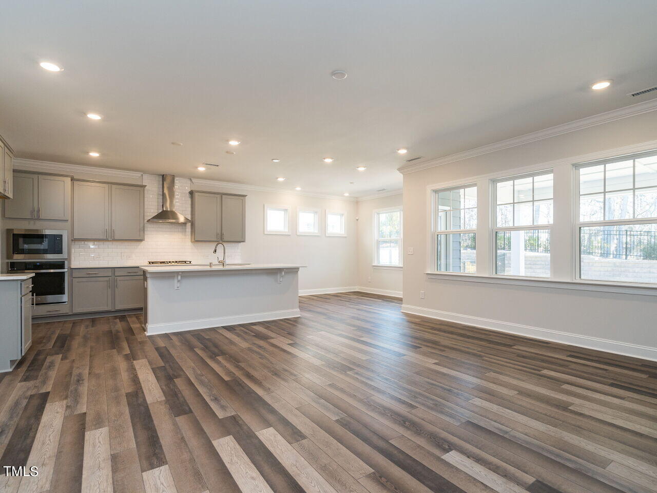 172 Mahogany Run Raleigh, NC 27610 - Photo 30 of 31 a large kitchen with stainless steel appliances kitchen island granite countertop a large window a island and a sink