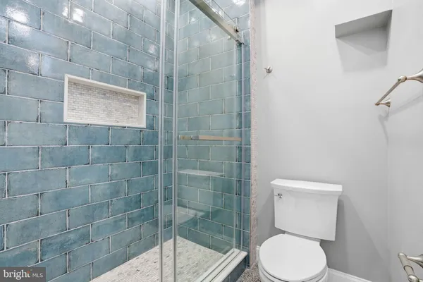 a bathroom with a toilet and a shower
