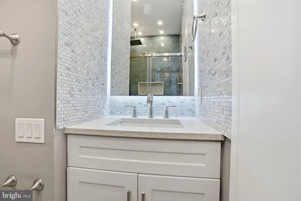 a bathroom with a sink and a mirror