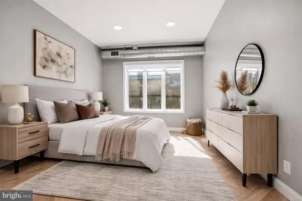 a bedroom with a bed and a large window