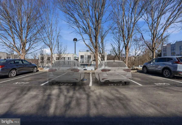a couple of cars parked in front of a house