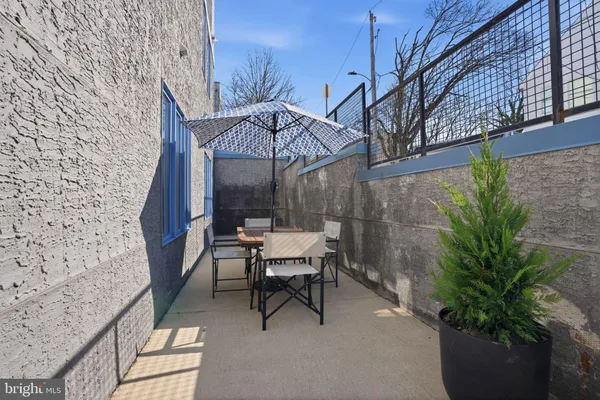 a view of a patio with a table and chairs