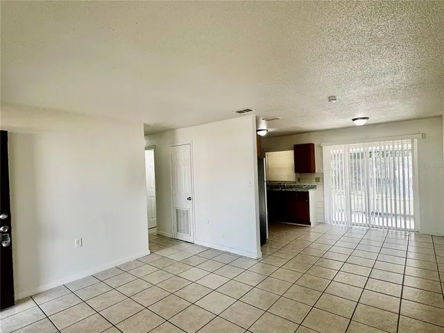 a view of a kitchen with a sink and a refrigerator