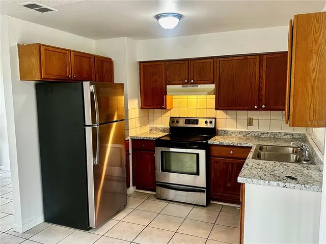 a kitchen with a refrigerator and a sink