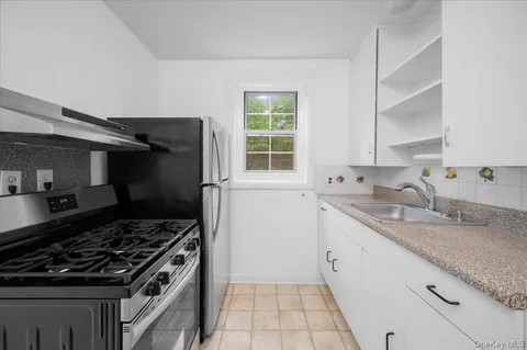a kitchen that has a sink and a stove