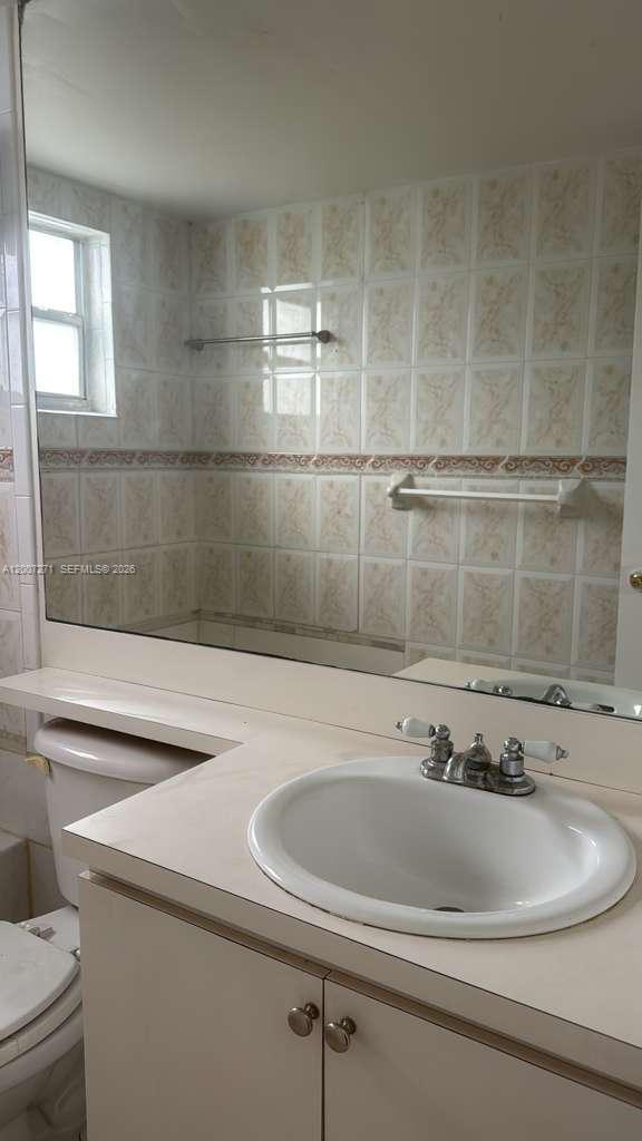 1655 West 44th Place, Unit 451 Hialeah, FL 33012 - Photo 9 of 12 a bathroom with a sink and a window