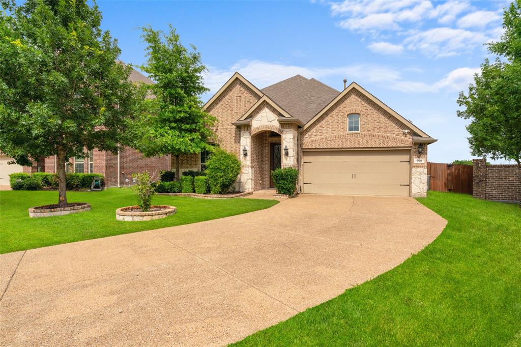 600 Fishback Circle Plano, TX 75074 - Photo 4 of 38 a view of a white house with a big yard and potted plants