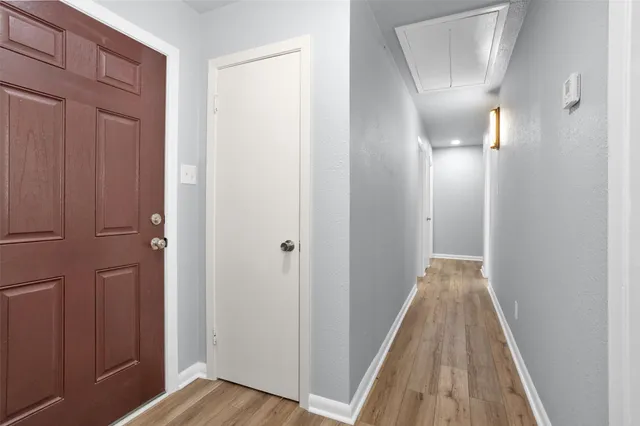 a view of a hallway with wooden floor