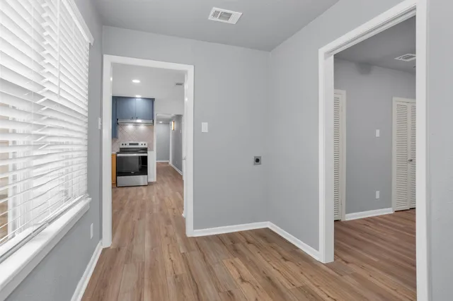 a view of a hallway with wooden floor
