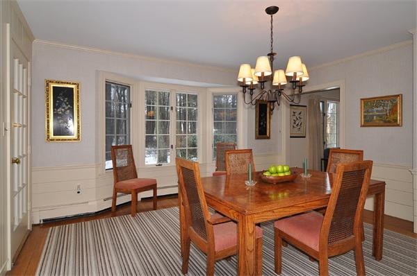 115 Winding River Road Needham, MA 02492 - Photo 4 of 15 a view of a dining room with furniture wooden floor and chandelier