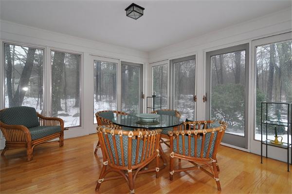 115 Winding River Road Needham, MA 02492 - Photo 8 of 15 a living room with furniture and a floor to ceiling window