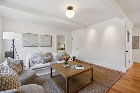 a bathroom with a granite countertop sink a toilet and mirror