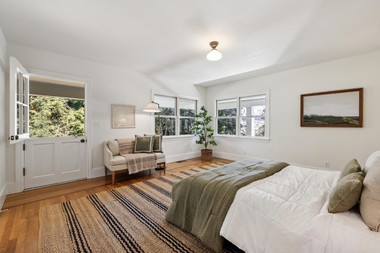 653 Larkin Valley Road Watsonville, CA 95076 - Photo 21 of 116 a bedroom with a bed and wooden floor