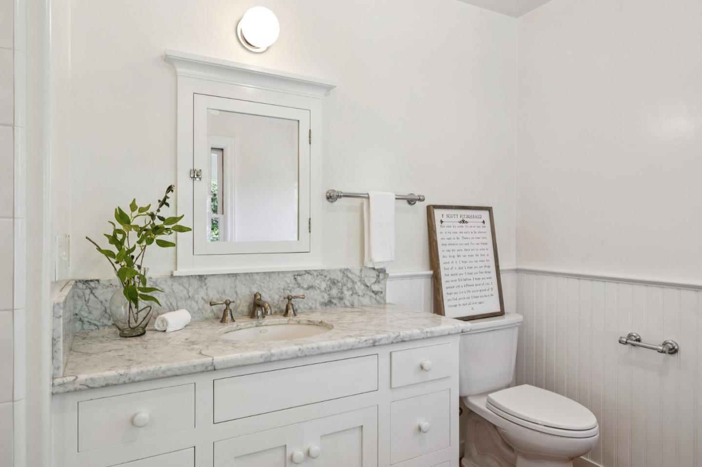 653 Larkin Valley Road Watsonville, CA 95076 - Photo 30 of 116 a bathroom with a granite countertop sink a toilet and mirror