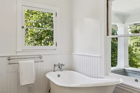 a bathroom with a granite countertop sink a toilet and shower