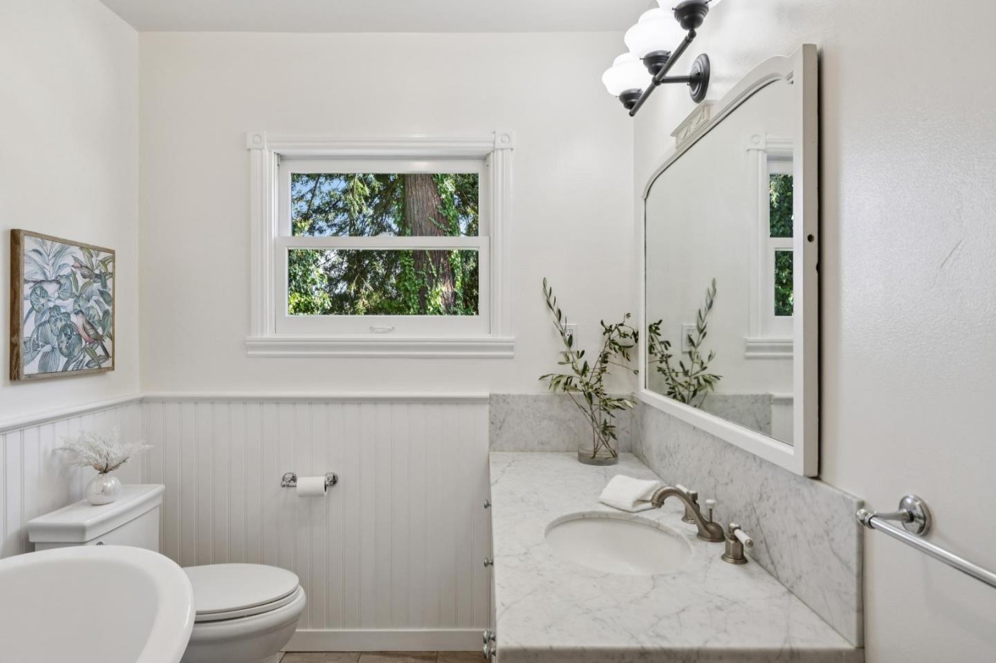 653 Larkin Valley Road Watsonville, CA 95076 - Photo 36 of 116 a bathroom with a granite countertop sink mirror vanity and toilet