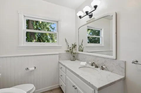 a view of a patio with table and chairs with wooden floor and fence