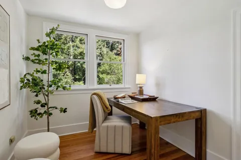 a view of a pathway both side of grassy field with trees