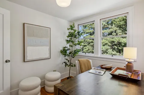 a view of a field with trees in the background
