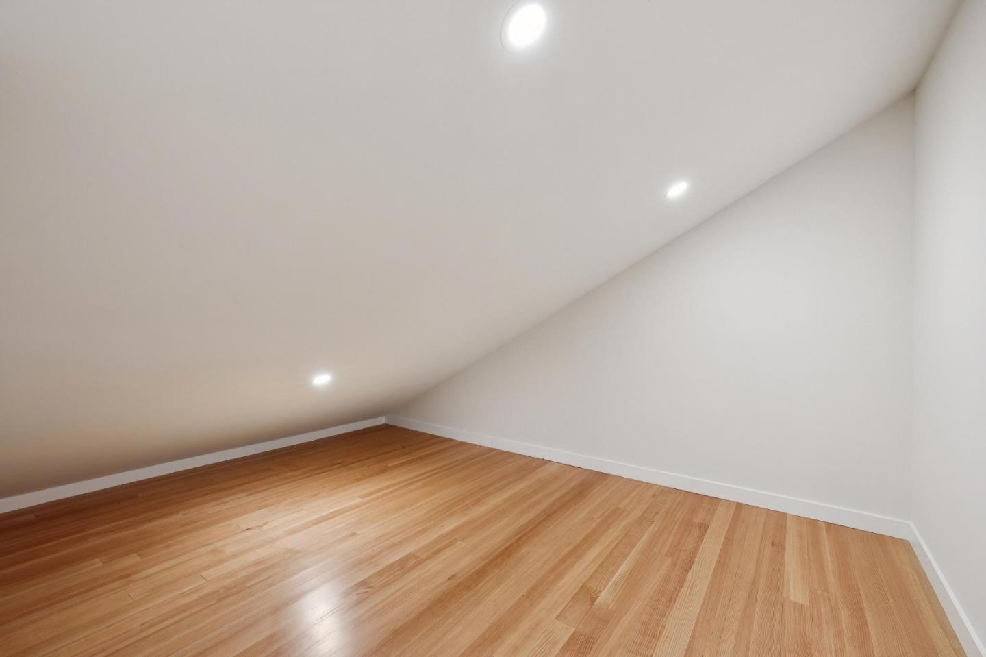 653 Larkin Valley Road Watsonville, CA 95076 - Photo 43 of 116 a view of an empty room with wooden floor and fan
