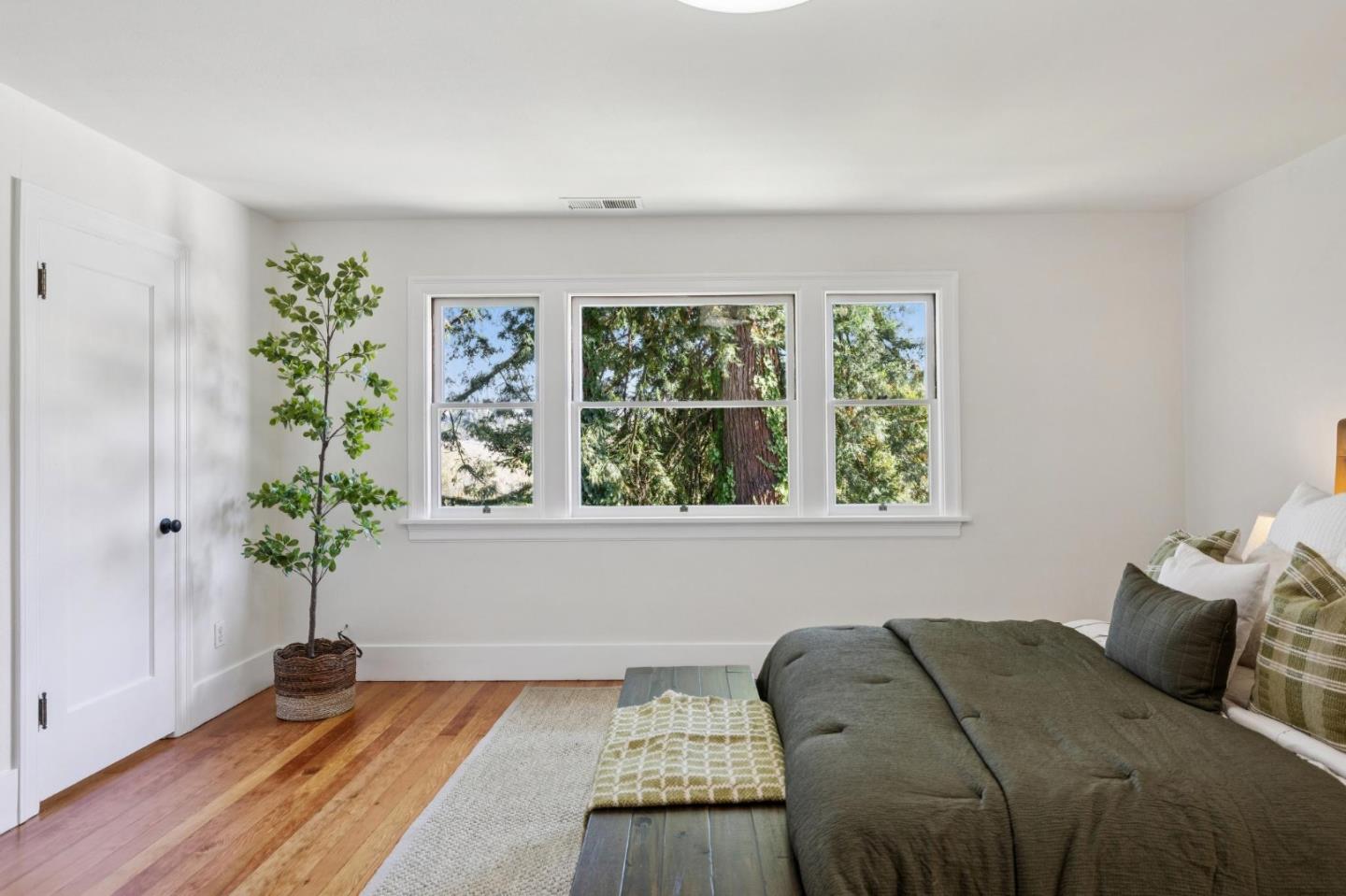 653 Larkin Valley Road Watsonville, CA 95076 - Photo 52 of 116 a bedroom with a bed and a potted plant