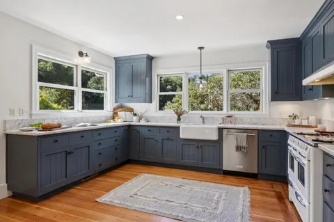 a kitchen with stainless steel appliances a stove a refrigerator and cabinets