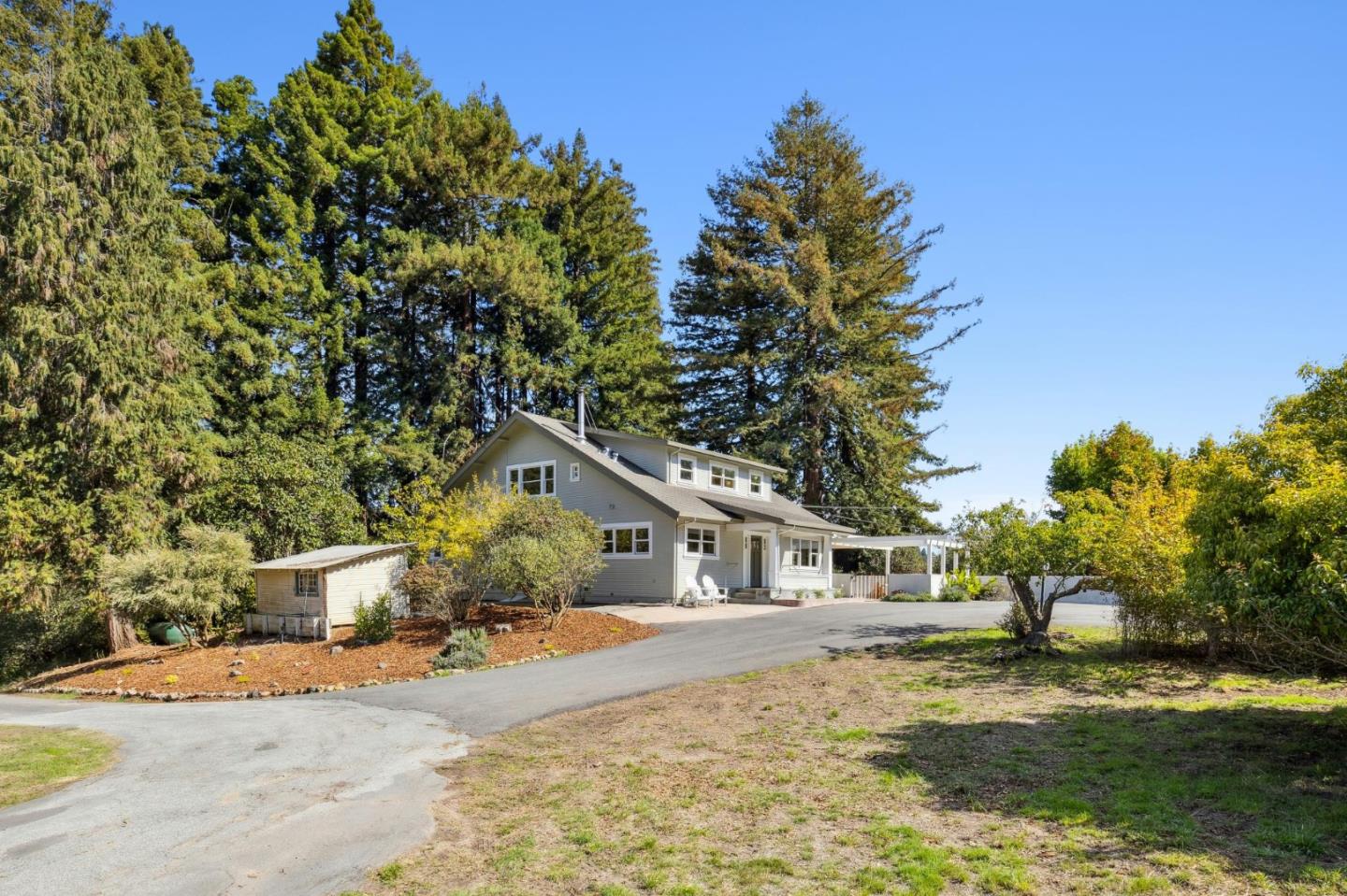 653 Larkin Valley Road Watsonville, CA 95076 - Photo 97 of 116 a front view of a house with a yard and garage