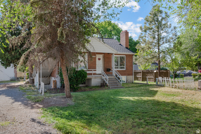 1275 North Geneva Road Provo, UT 84601 - Photo 1 of 25 Brick exterior featuring a gabled roof and prominent chimney