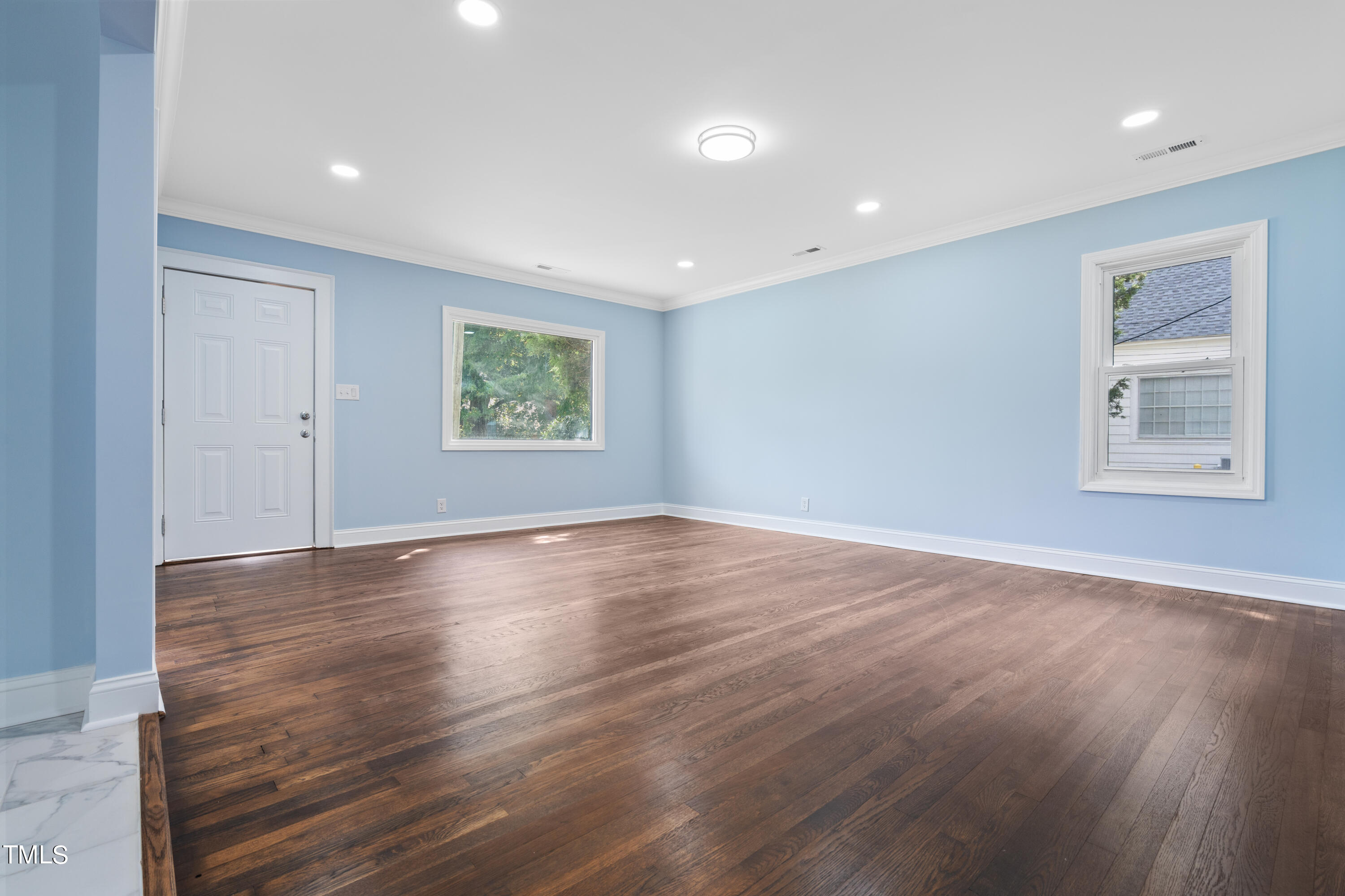 244 Semora Road Roxboro, NC 27573 - Photo 11 of 42 a view of an empty room with wooden floor and a window