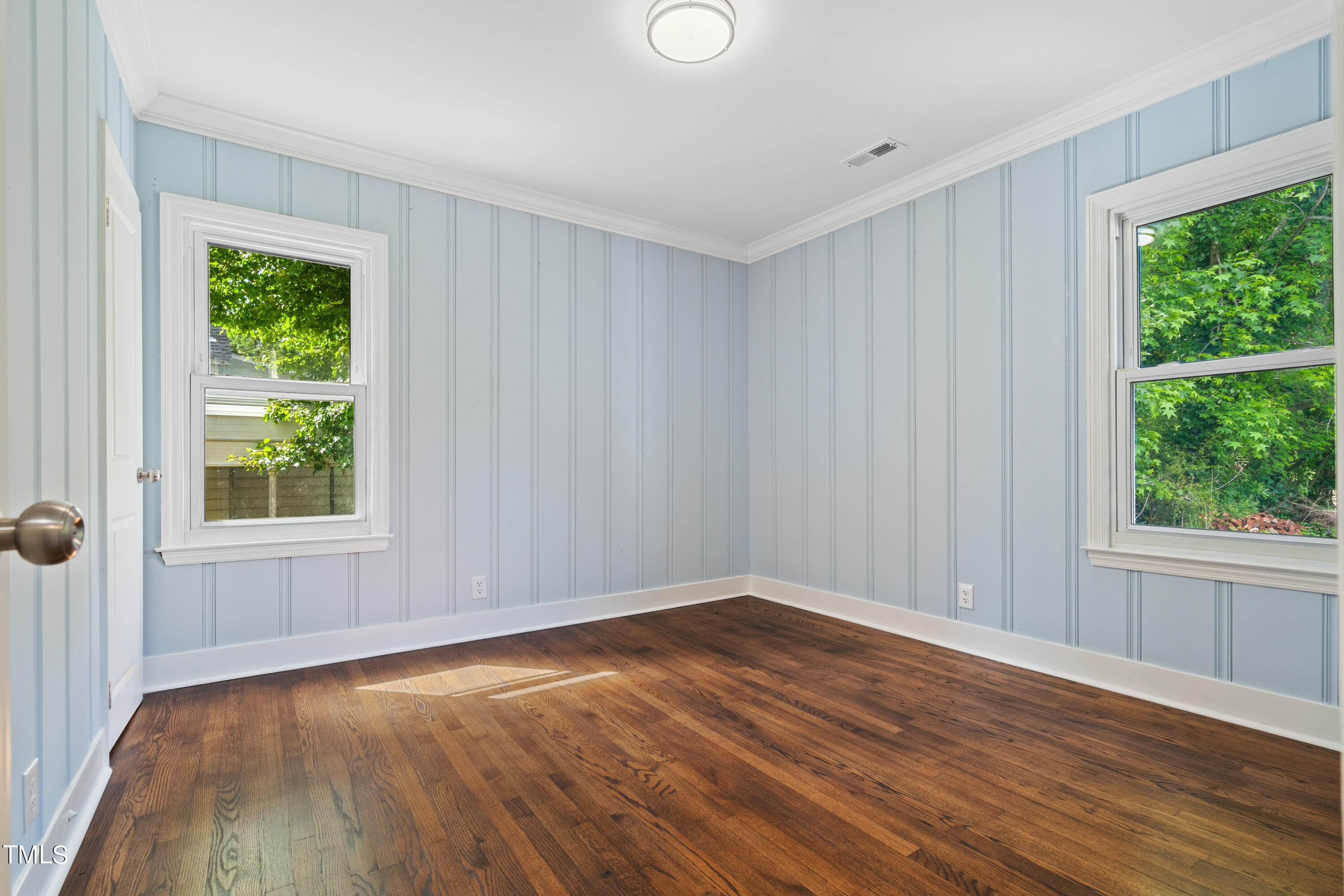 244 Semora Road Roxboro, NC 27573 - Photo 13 of 42 an empty room with wooden floor and windows