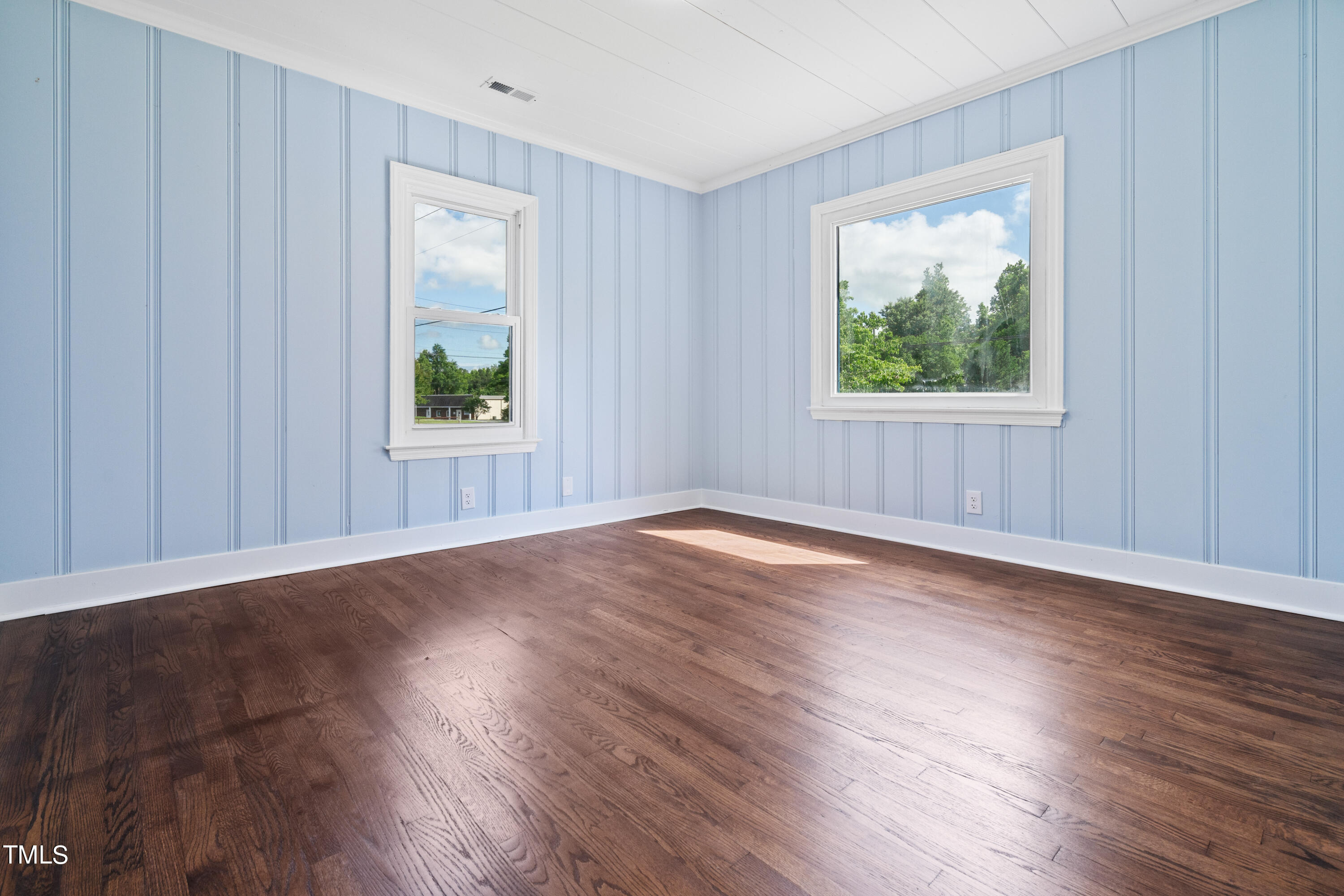 244 Semora Road Roxboro, NC 27573 - Photo 14 of 42 an empty room with wooden floor and windows