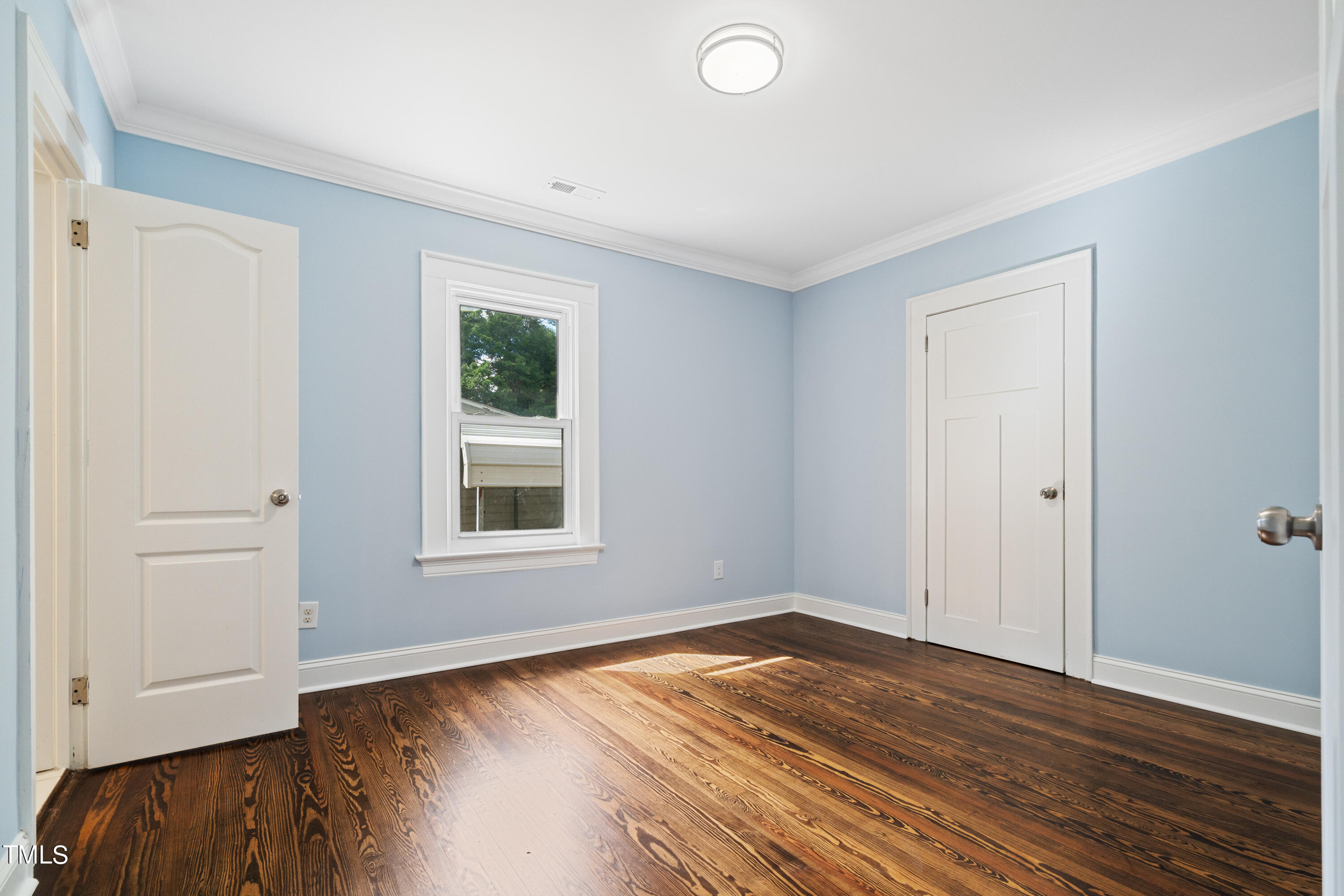 244 Semora Road Roxboro, NC 27573 - Photo 16 of 42 an empty room with wooden floor and window