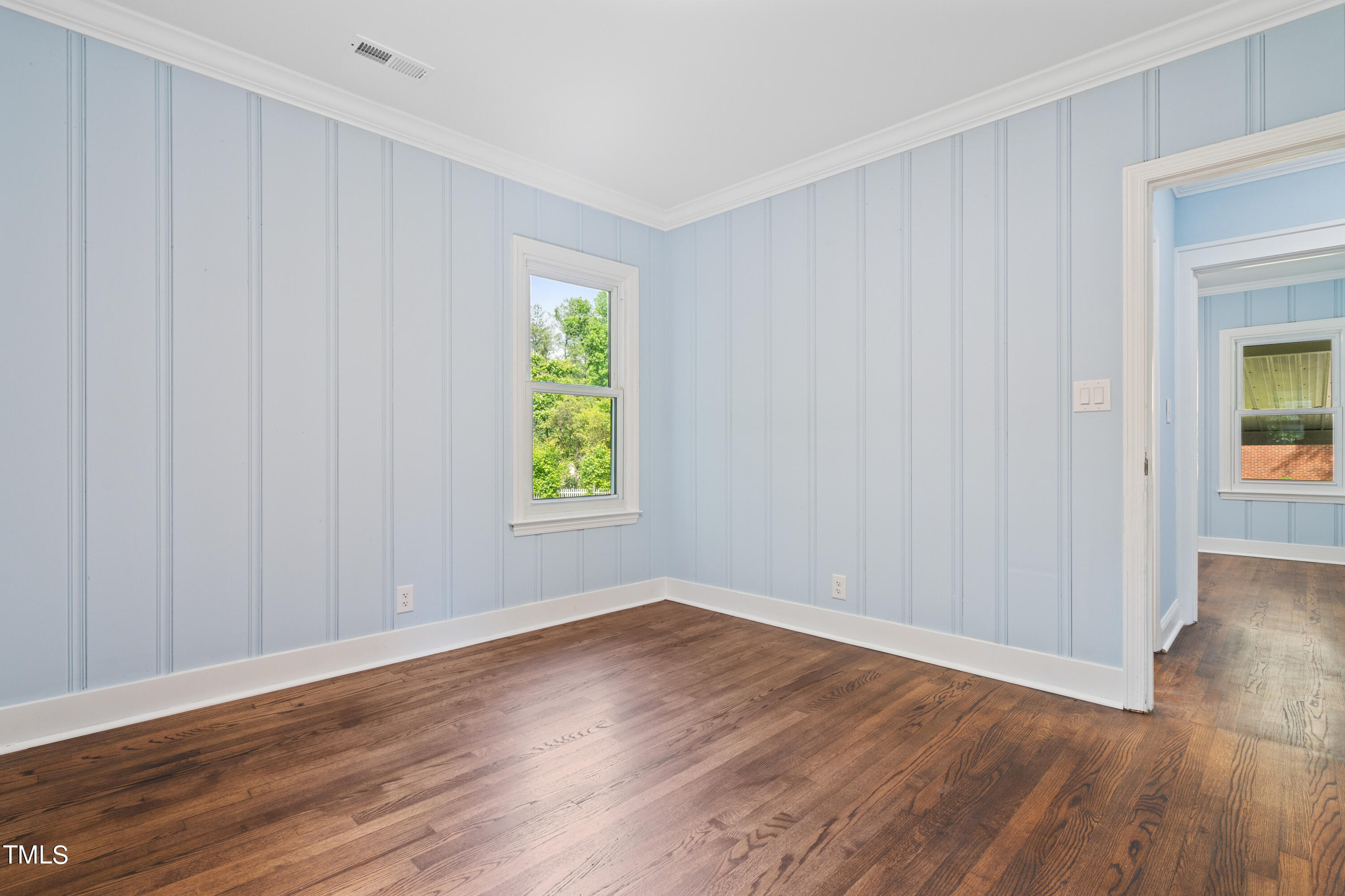 244 Semora Road Roxboro, NC 27573 - Photo 20 of 42 a view of an empty room with wooden floor and a window