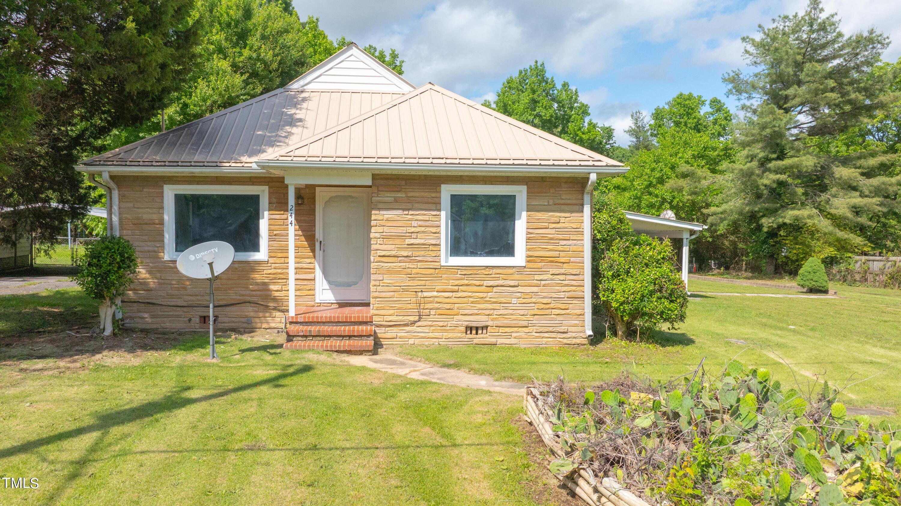 244 Semora Road Roxboro, NC 27573 - Photo 2 of 42 a front view of a house with a yard