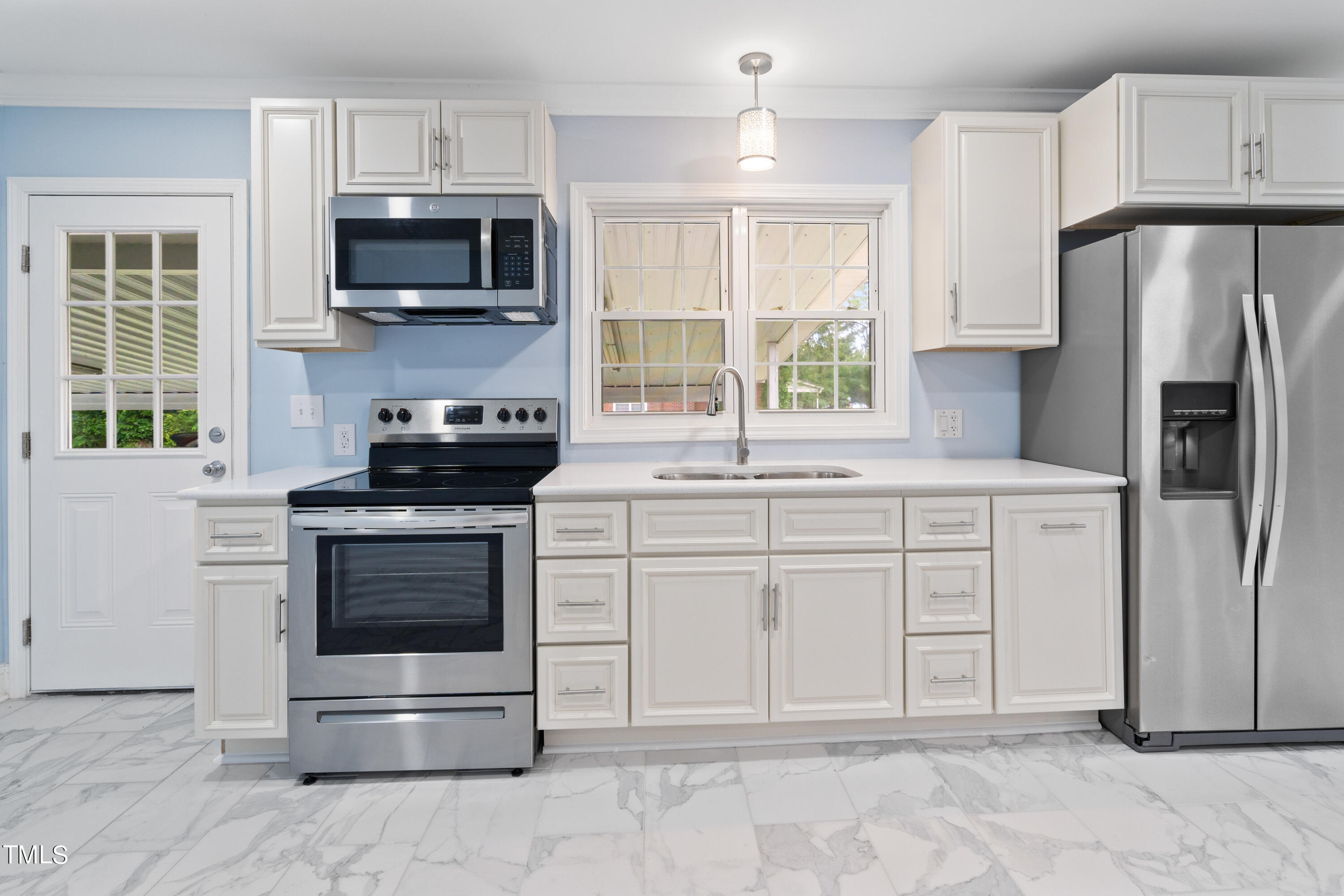 244 Semora Road Roxboro, NC 27573 - Photo 24 of 42 a kitchen with white cabinets and stainless steel appliances