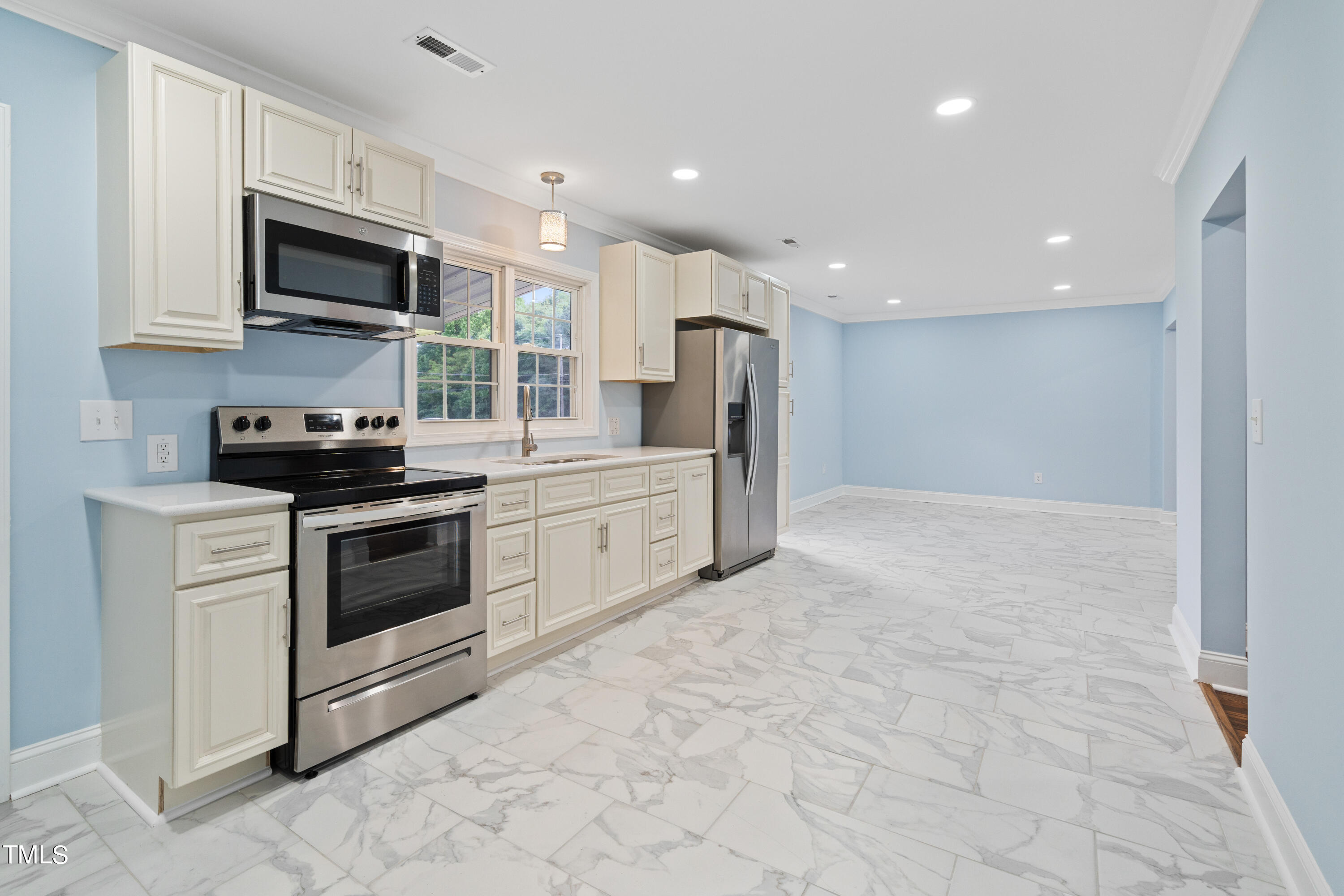 244 Semora Road Roxboro, NC 27573 - Photo 25 of 42 a kitchen with stainless steel appliances granite countertop a stove a sink and a microwave