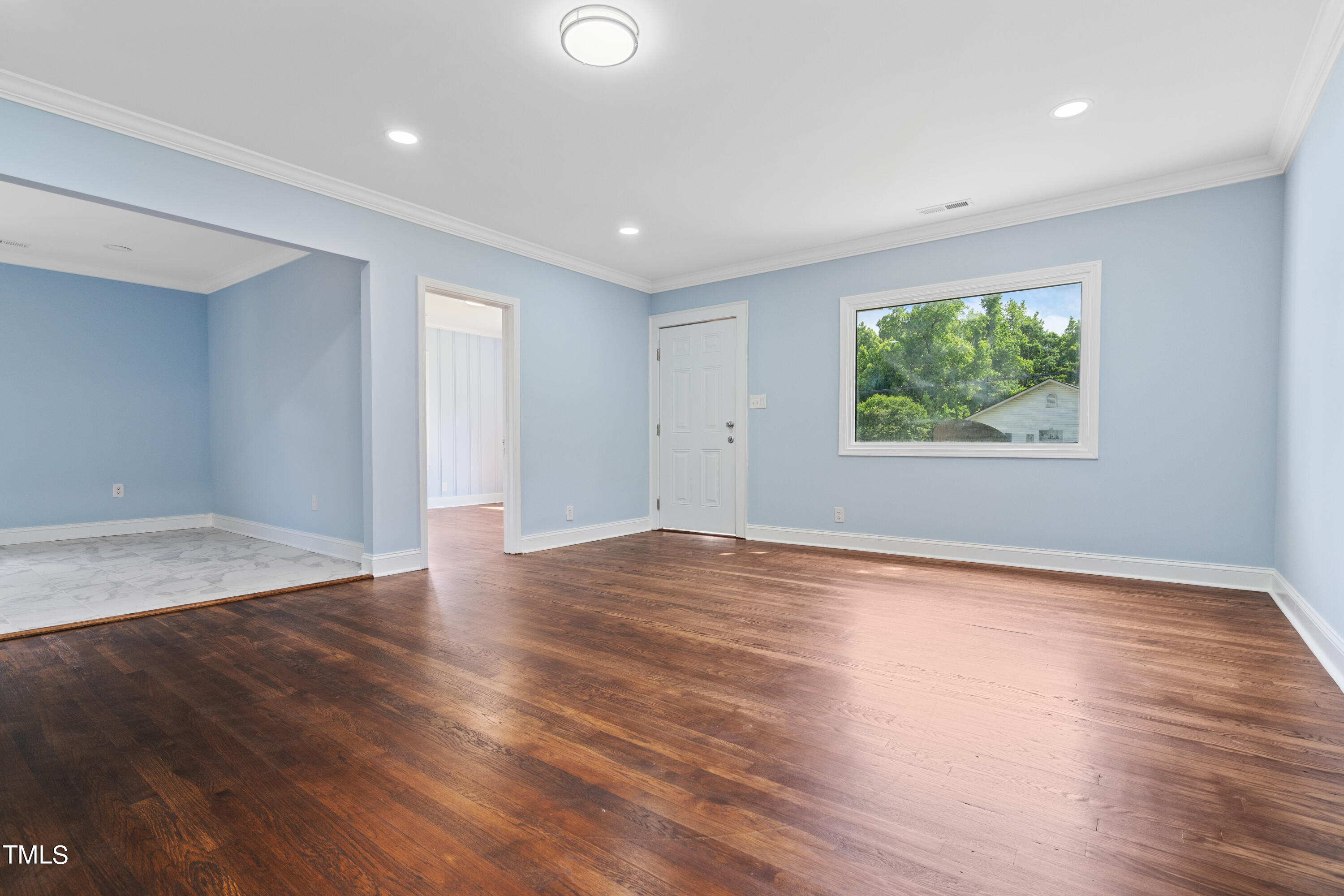 244 Semora Road Roxboro, NC 27573 - Photo 28 of 42 an empty room with wooden floor and windows