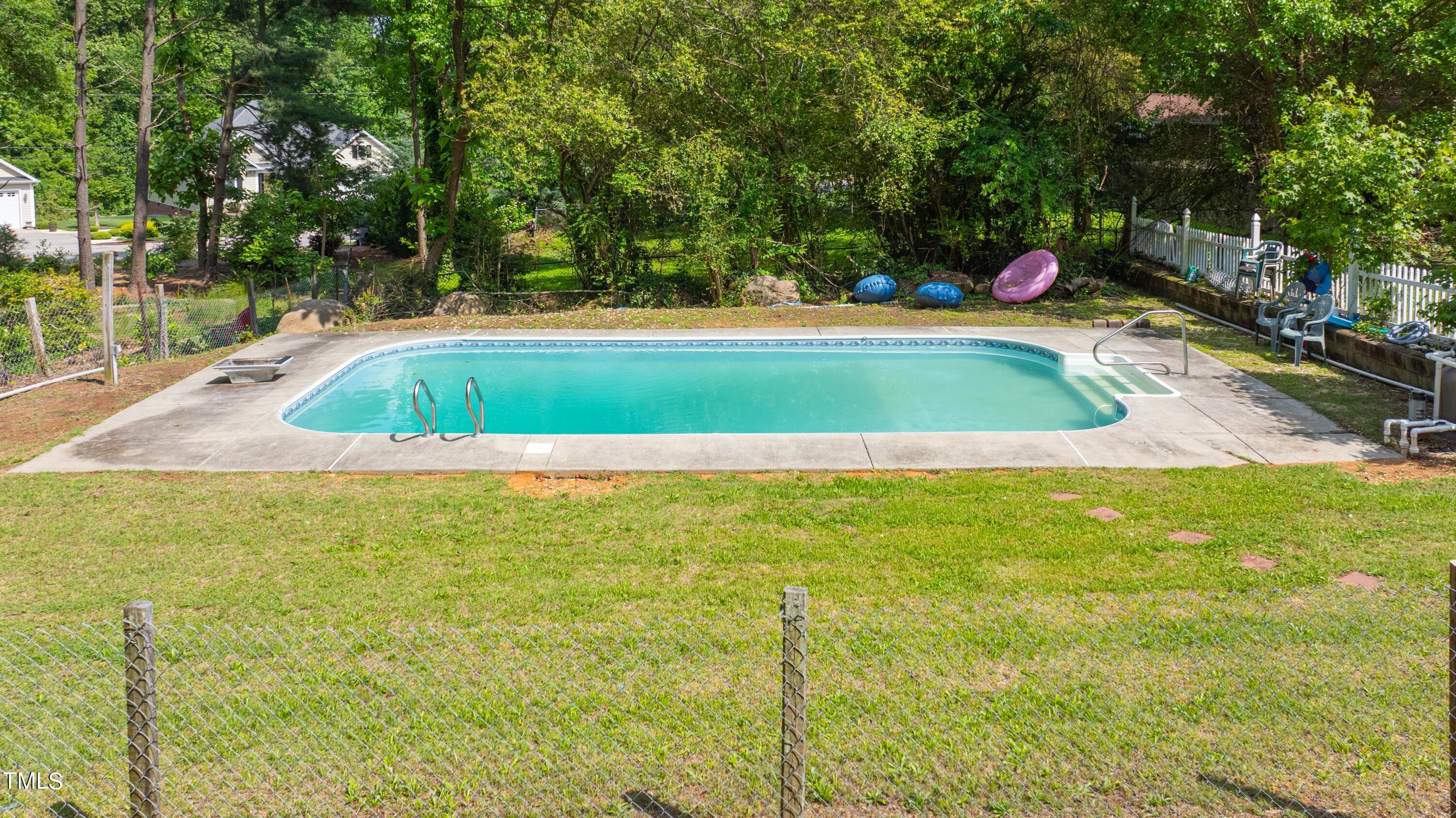 244 Semora Road Roxboro, NC 27573 - Photo 3 of 42 a view of a swimming pool with a yard