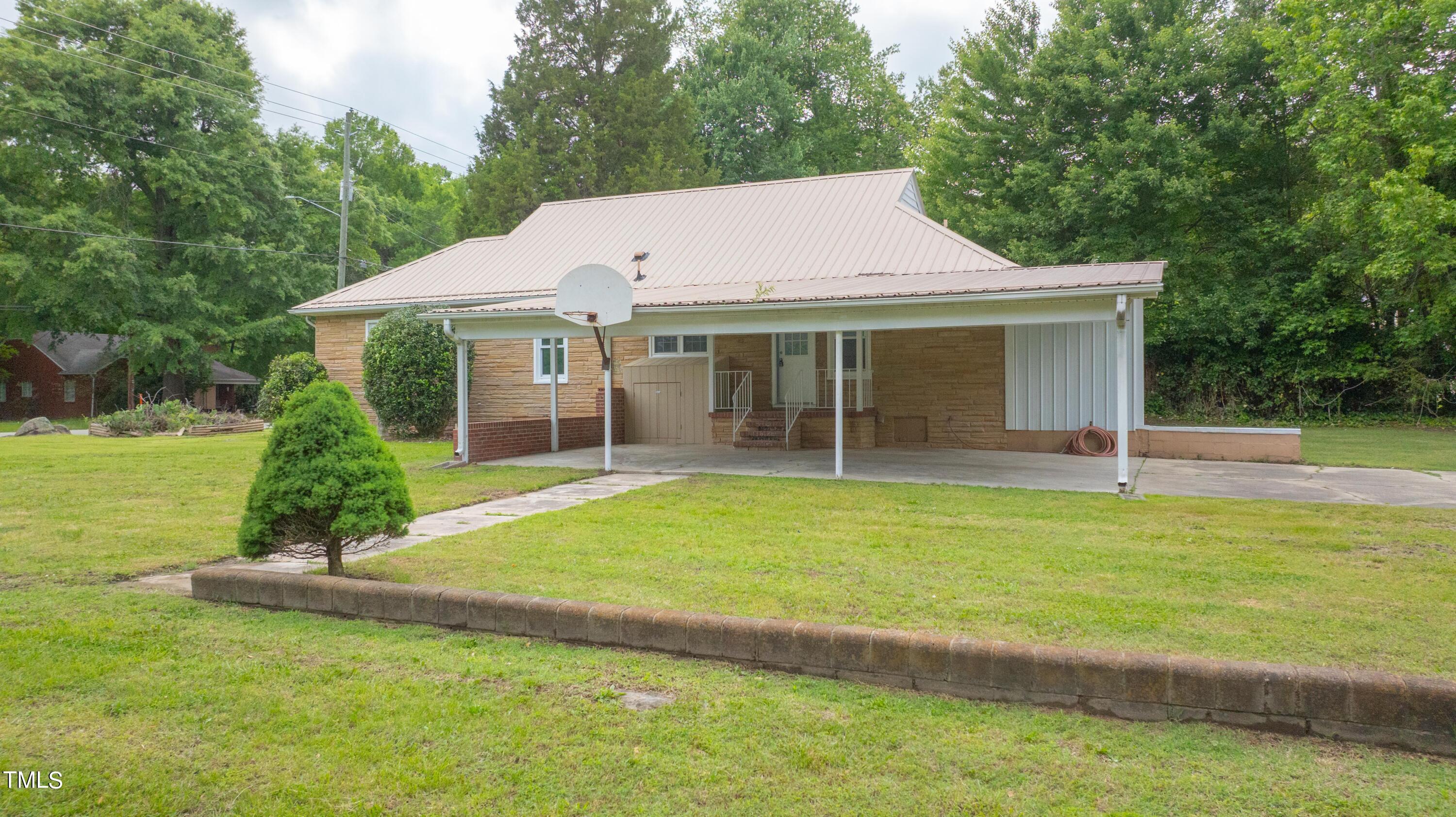 244 Semora Road Roxboro, NC 27573 - Photo 34 of 42 a front view of a house with a garden