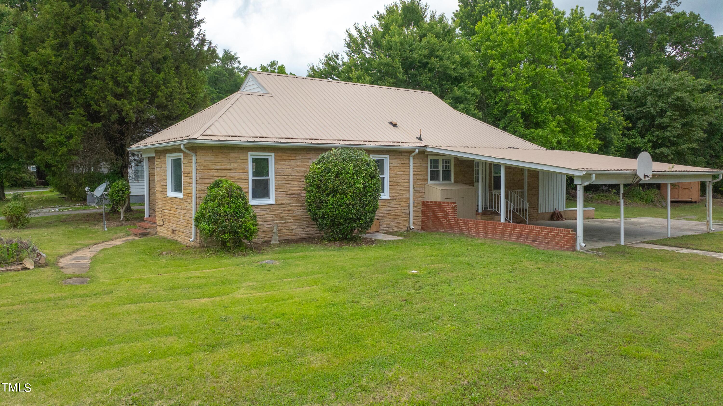244 Semora Road Roxboro, NC 27573 - Photo 38 of 42 a view of a house with backyard and garden