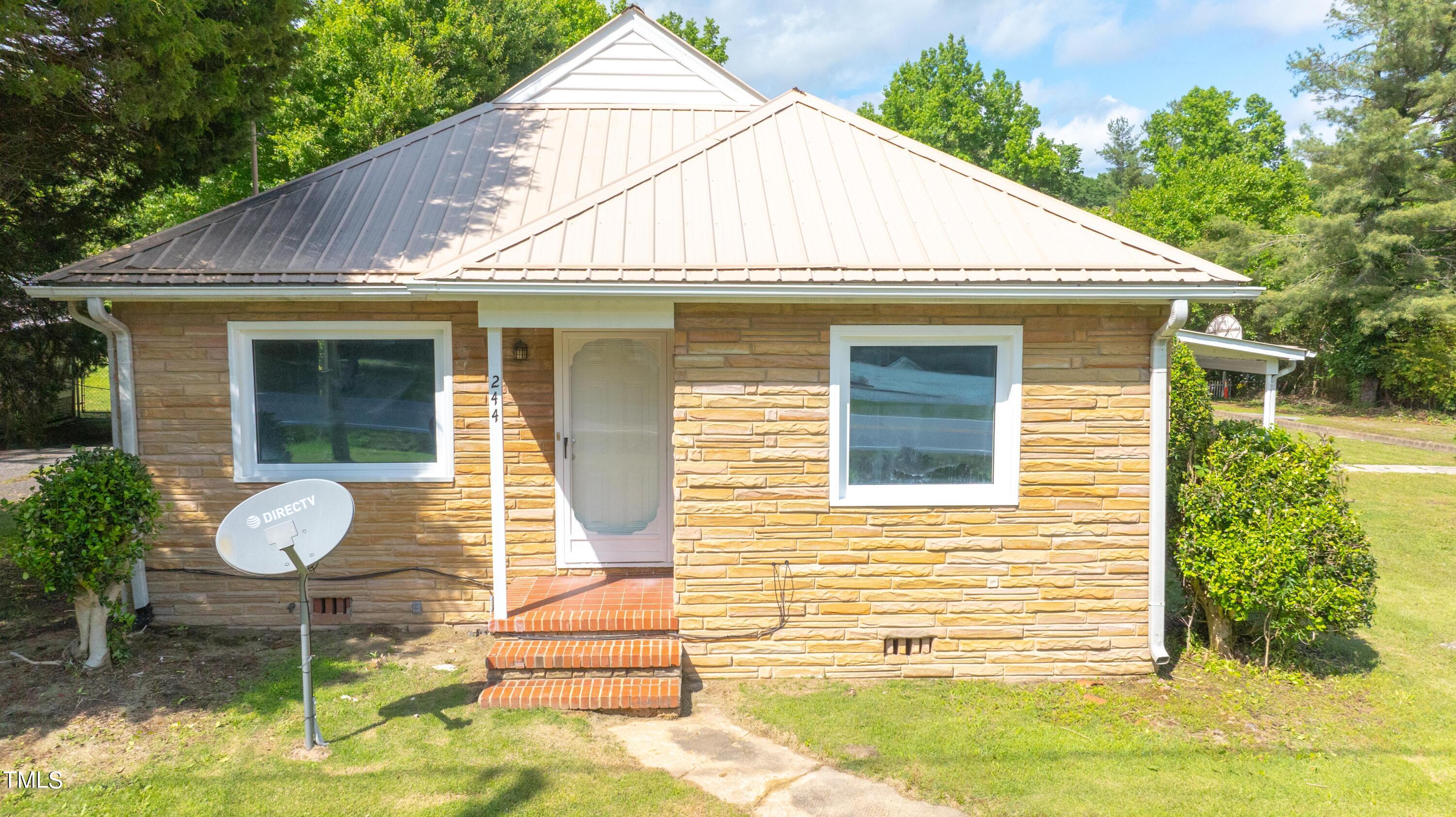 244 Semora Road Roxboro, NC 27573 - Photo 39 of 42 a view of a house with a yard and furniture
