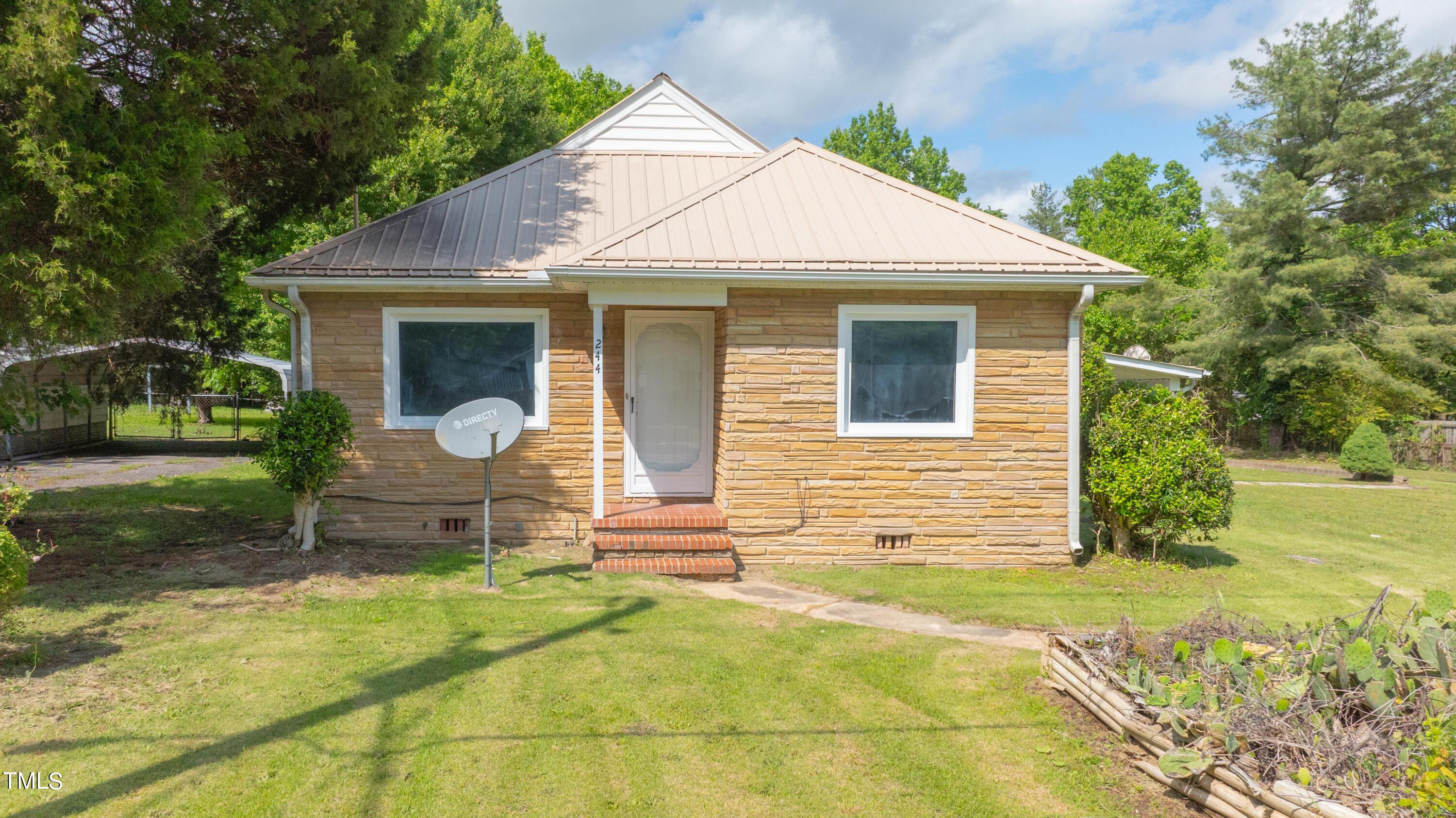 244 Semora Road Roxboro, NC 27573 - Photo 40 of 42 a front view of a house with a yard