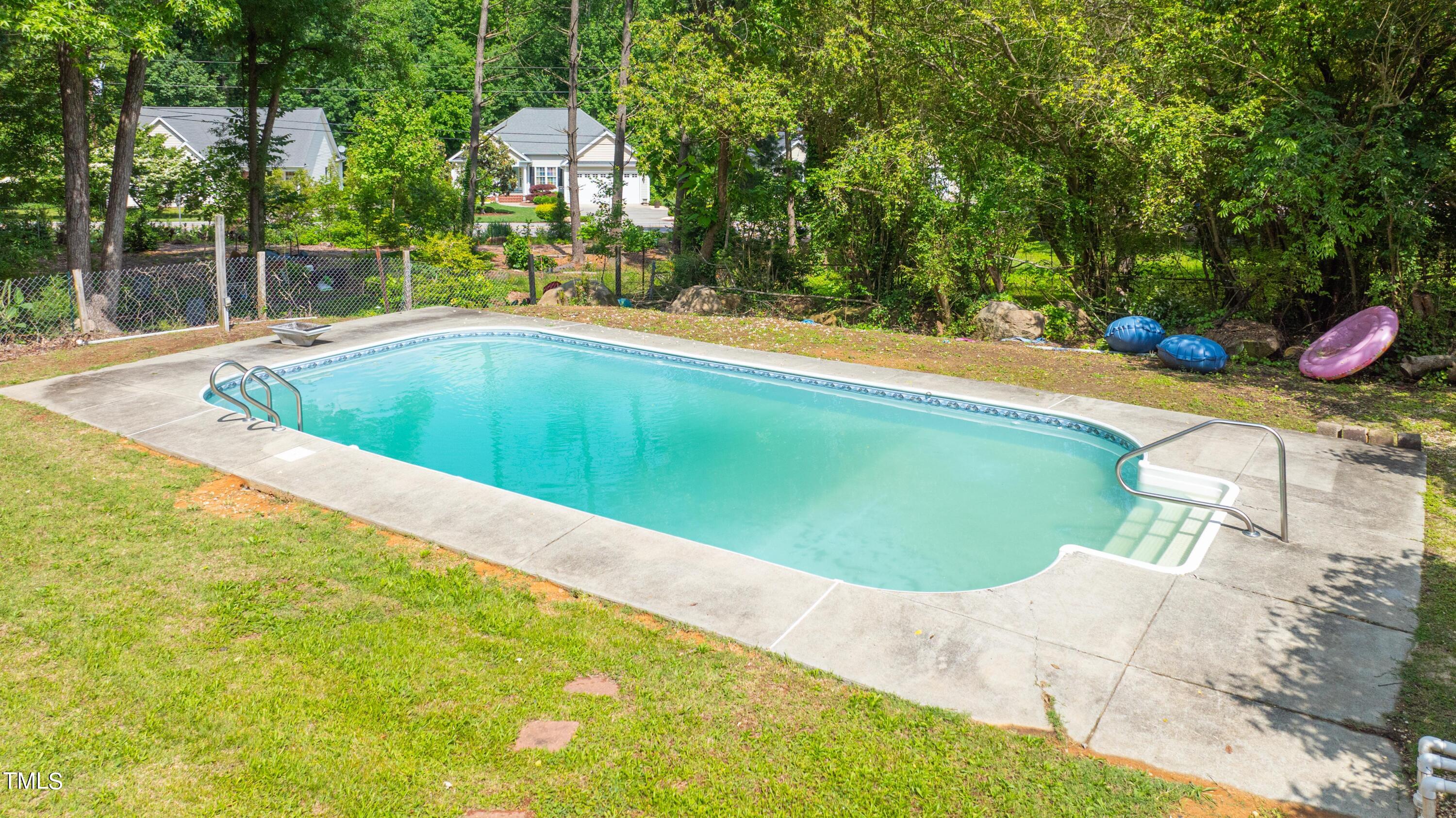 244 Semora Road Roxboro, NC 27573 - Photo 4 of 42 a view of a swimming pool with a patio and plants