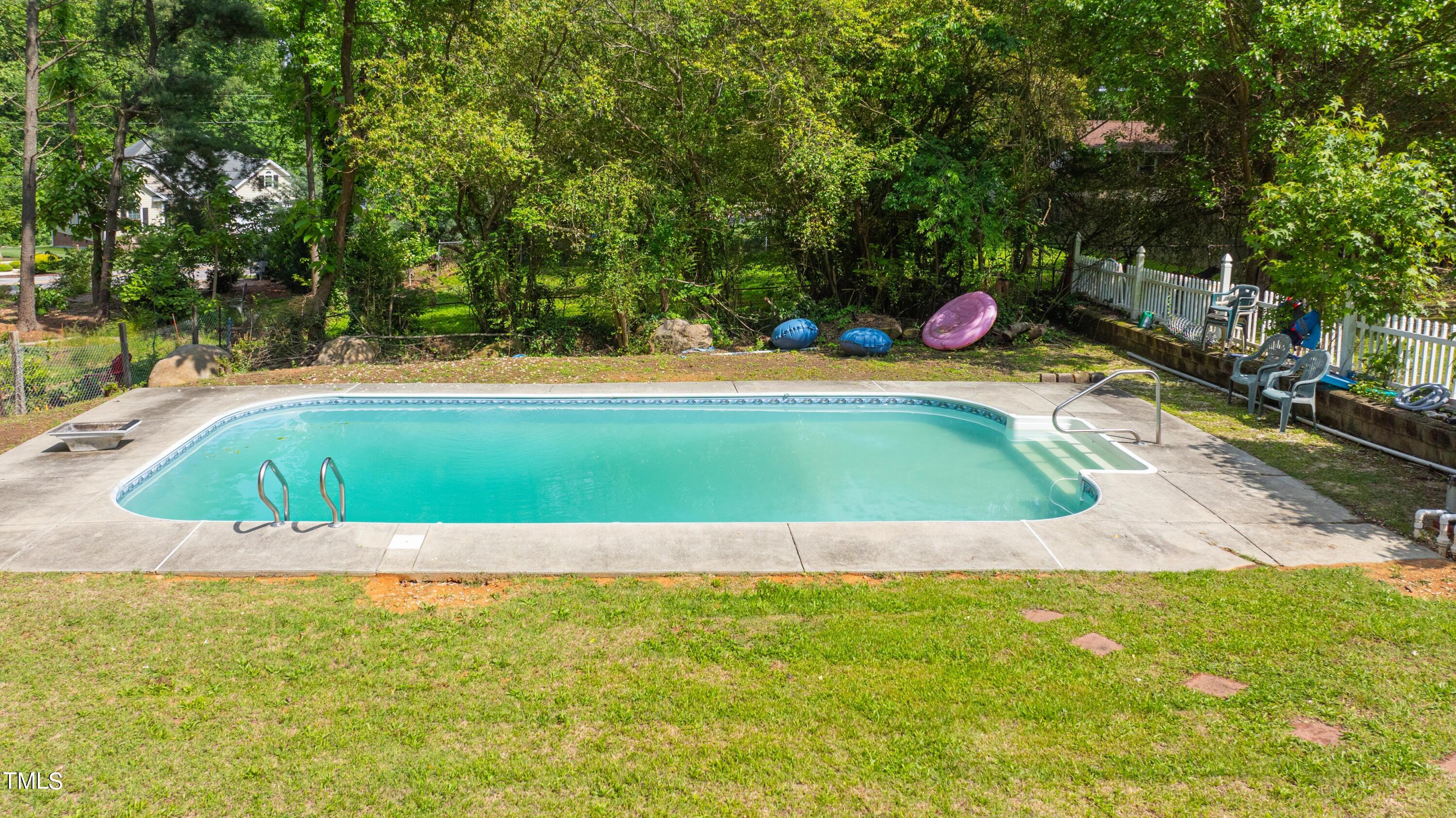 244 Semora Road Roxboro, NC 27573 - Photo 42 of 42 a view of pool with lawn chairs and large trees
